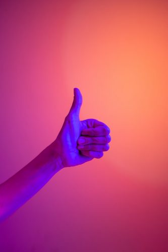 a thumbs up hand as a non-verbal communication cue