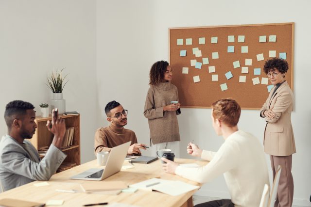 A lady leading a meeting of people