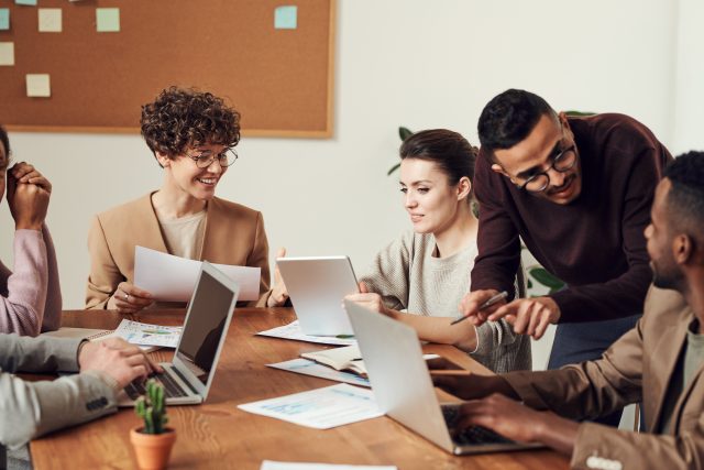 few people communicating among themselves at the workplace