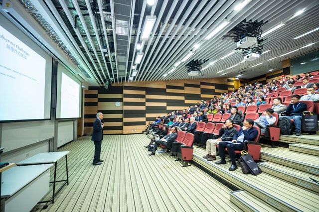 A public speaker addressing a large audience