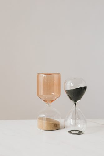 two hour glasses showing time management as a skill for work from home job
