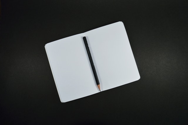 a pen kept in center of a notepad