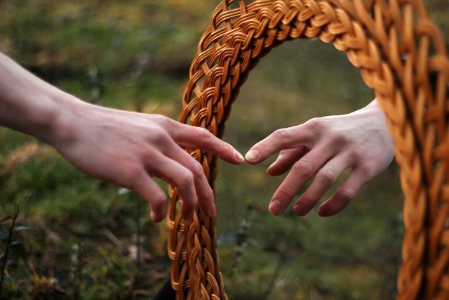 a finger touching itself through mirror- displaying self-awareness