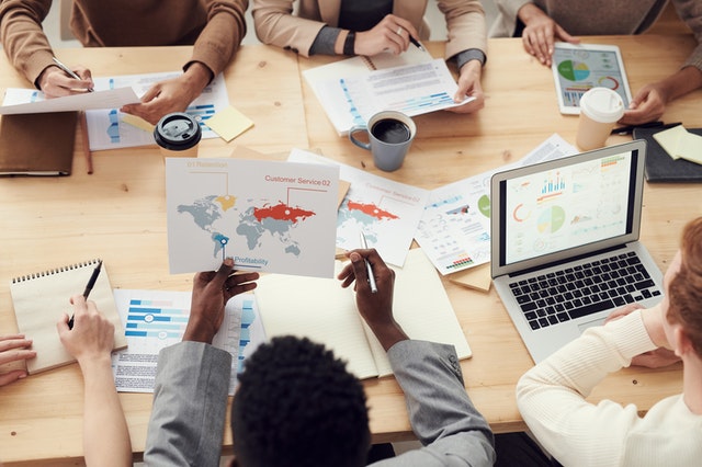 Employees looking at analytics to monitor the progress of project