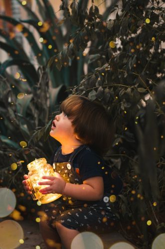 a curious boy looking at the lights around him